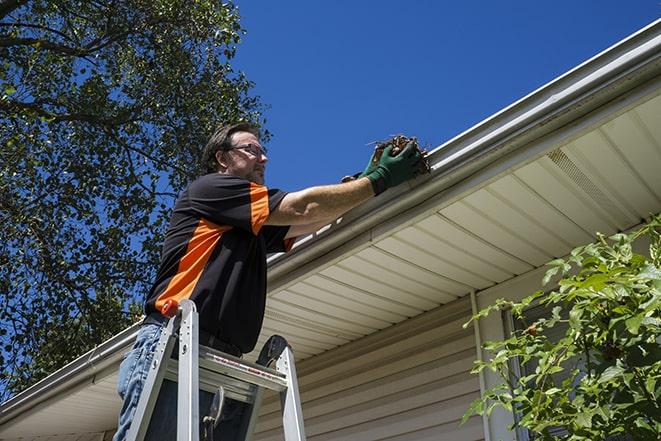 fixing a leaky gutter with new screws and brackets in Roseville MN